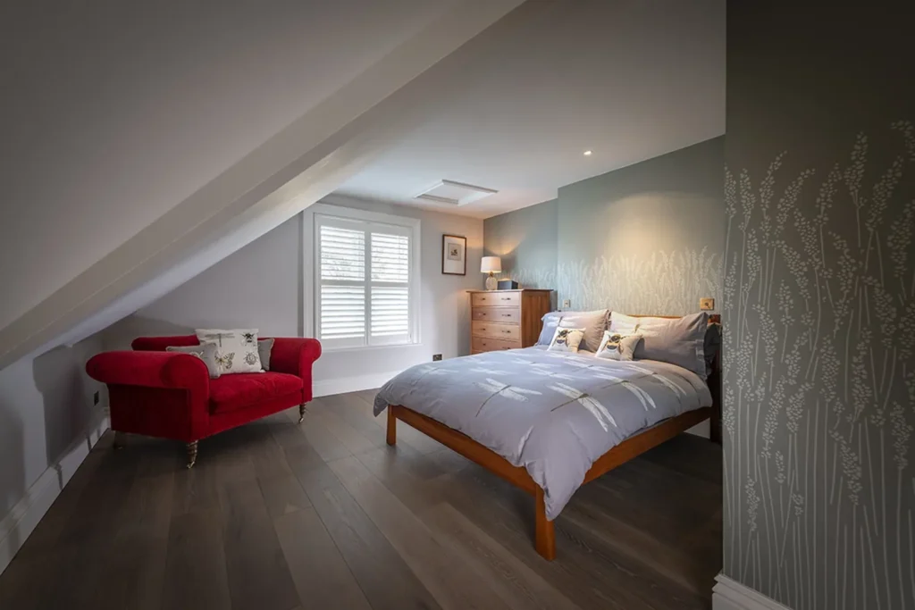 full height plantation shutters in white installed in a bed room in Winchester by The Great Shutter Co.